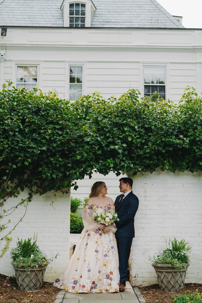 bride and groom posing in front of venue