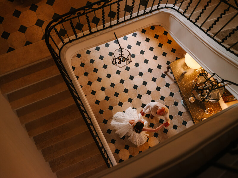 Wedding Dance Portrait Photoshoot Inside the Domaine, Black and White, with View of the Damier Chateau Carreau from the Stairs