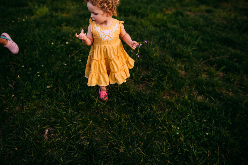 toddler girl playing in Forest park