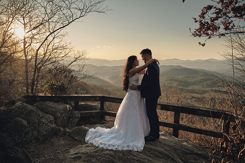Eloping couple dancing on amountaintop in Georgia