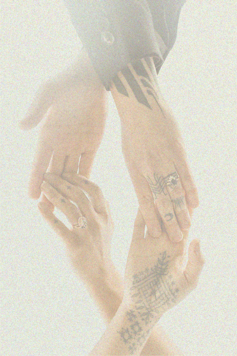 couple holding hands with tattoos