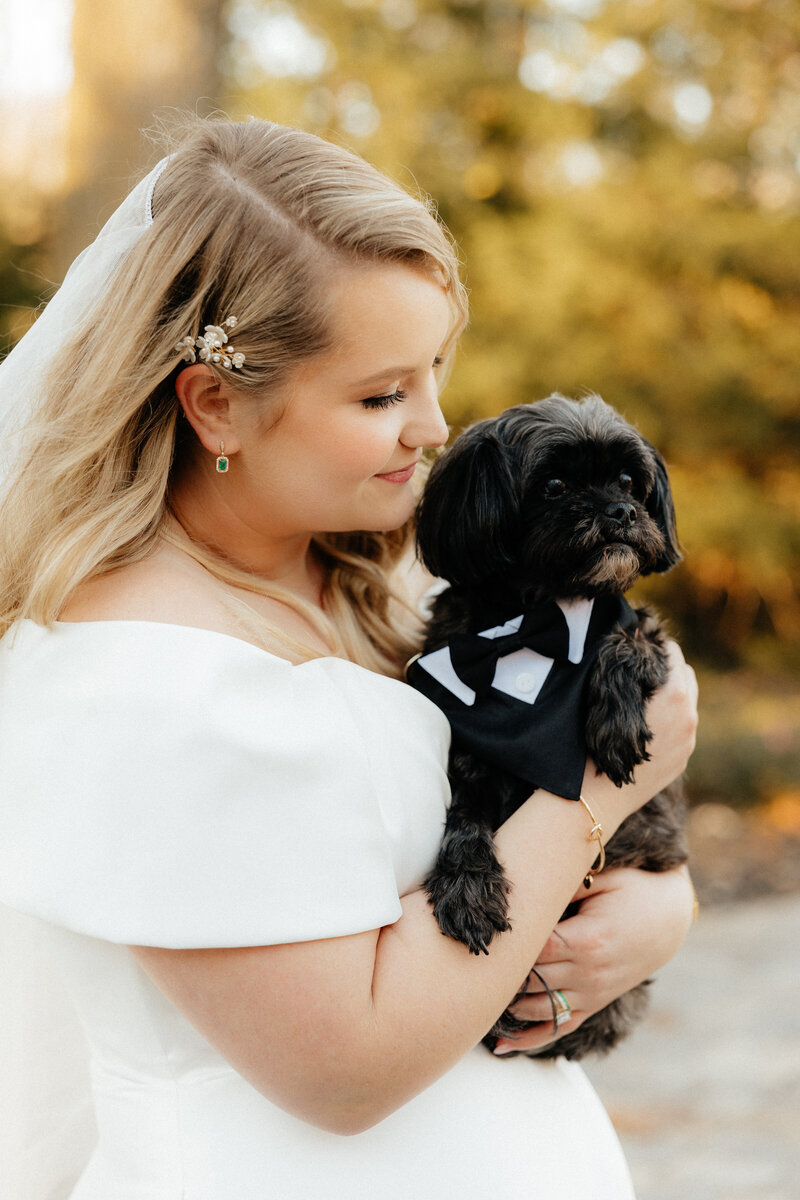 A bride holding her childhood dog.