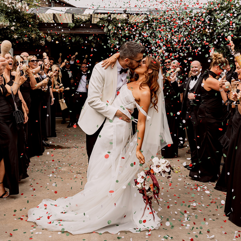 Couple kissing in confetti