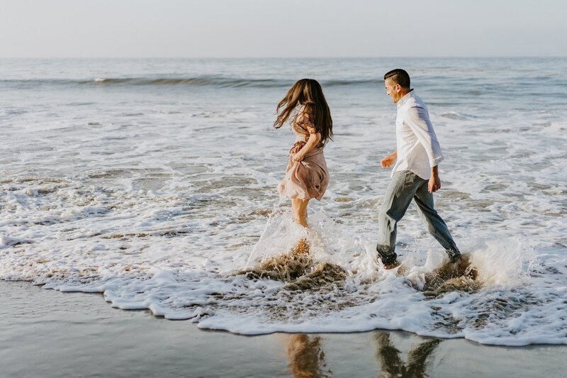 CA couple dance at El Matador beach in Malibu during sunrise engagement session
