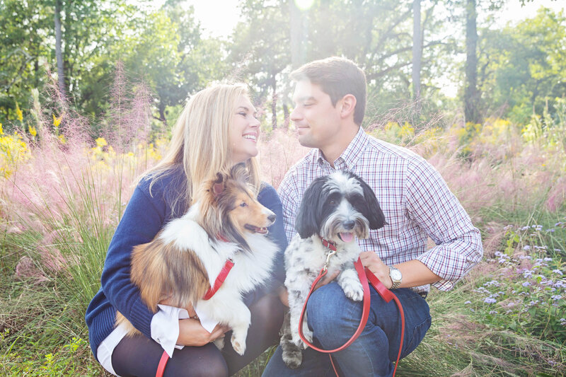couple holds their dogs