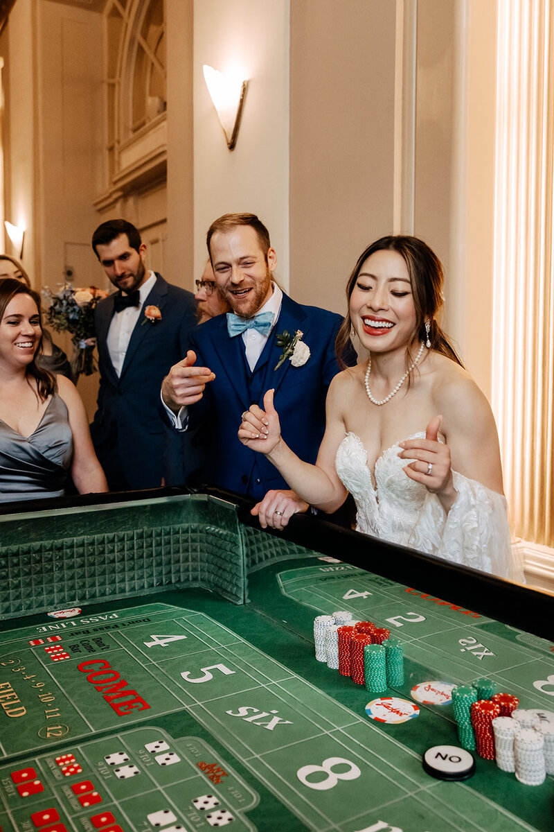 Bride and groom shoot craps at their wedding reception