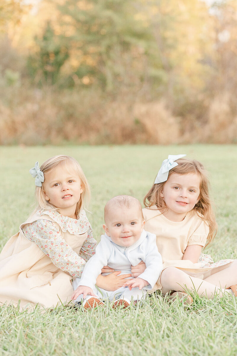3 siblings smiling taken by a Loudoun County, VA fall minis photographer