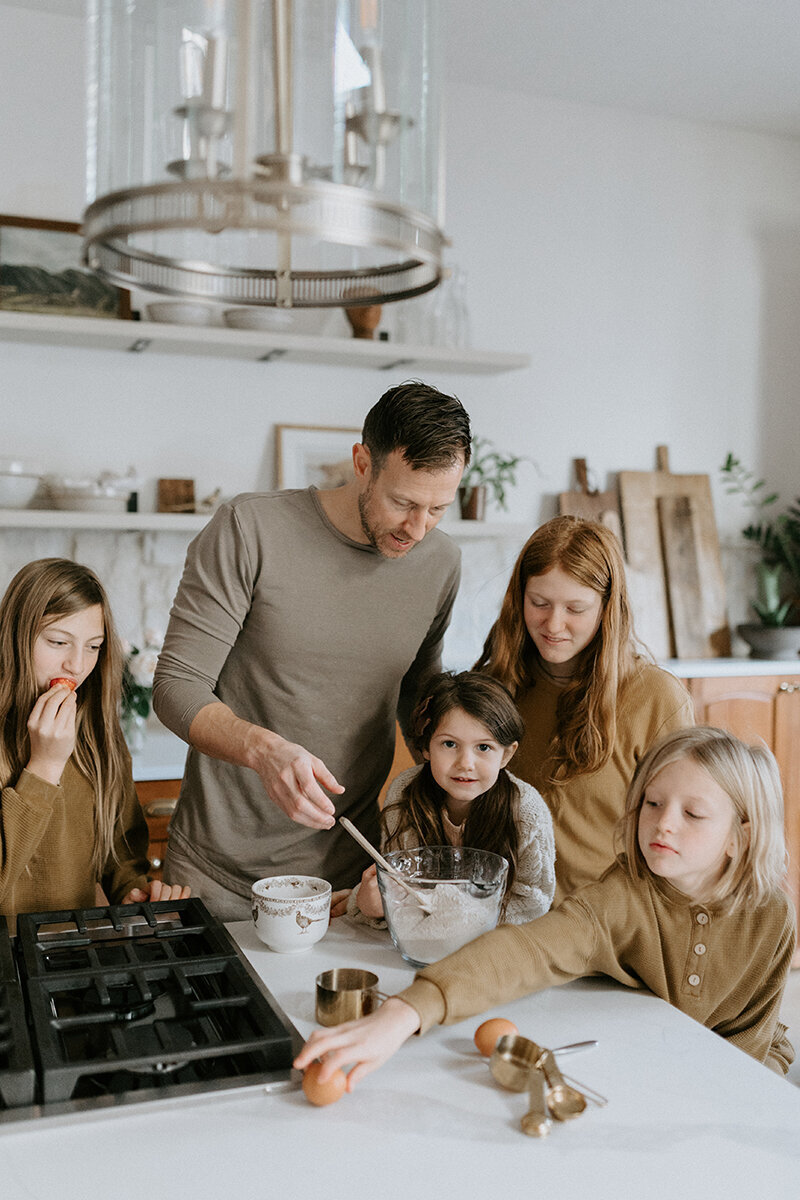A dad and his four daughters make pancakes together for their Lafayette, Indiana family photography session.