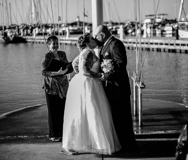 Bride and groom share first kiss at their Erie Yacht Club wedding