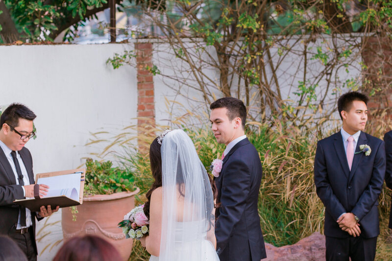 groom side glances at his bride, admiring her beauty
