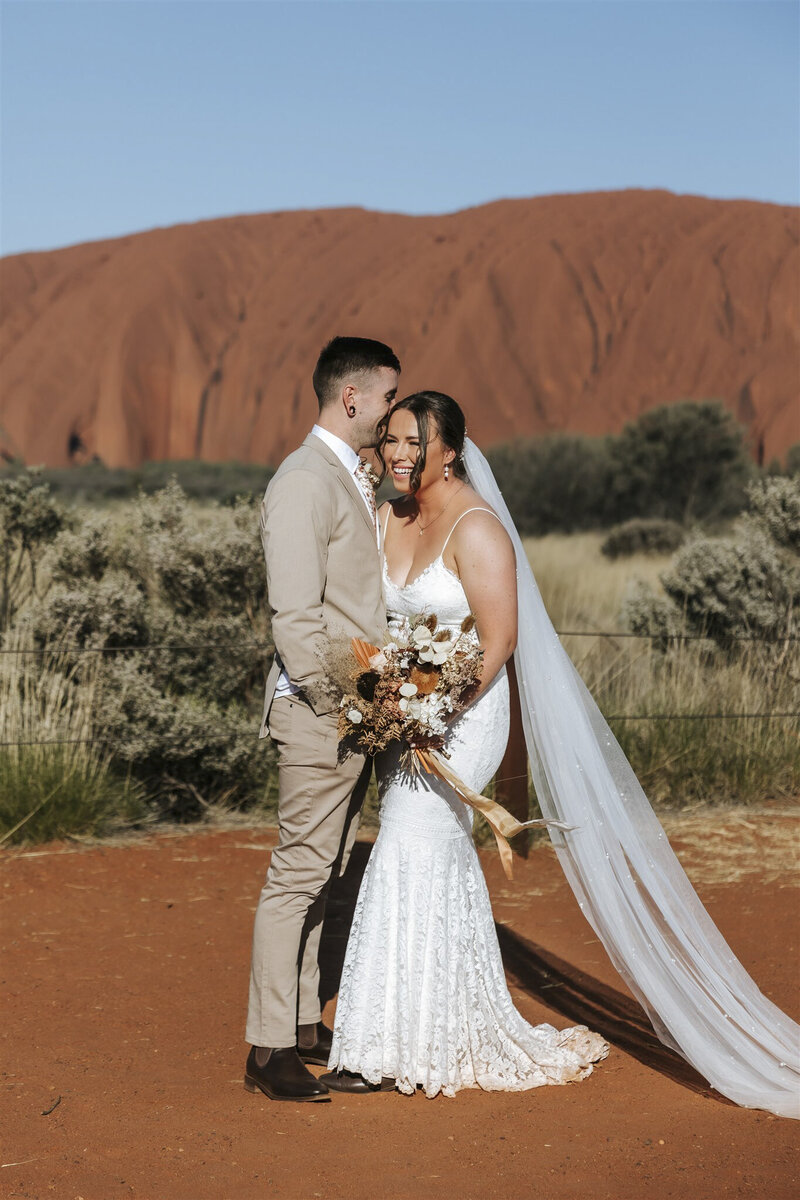 Uluru wedding showing a man and woman getting married with Uluru in the background