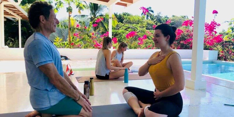 Students practicing teaching meditation techniques during yoga certification in Costa Rica