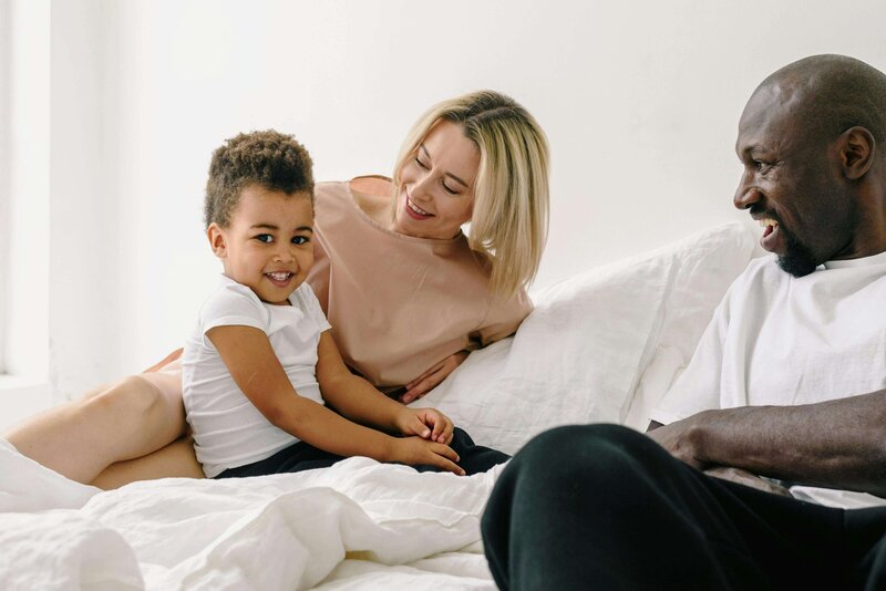 Mother and father laughing with son