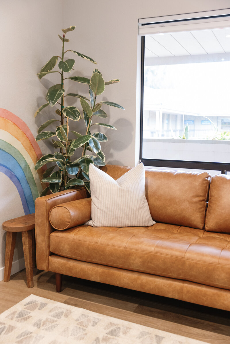 Couch with a pillow in the waiting area of the Santa Barbara Myo office.