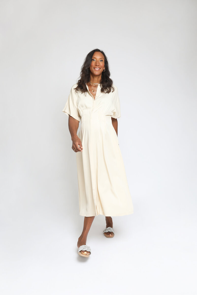 Alexandra smiling in cream dress