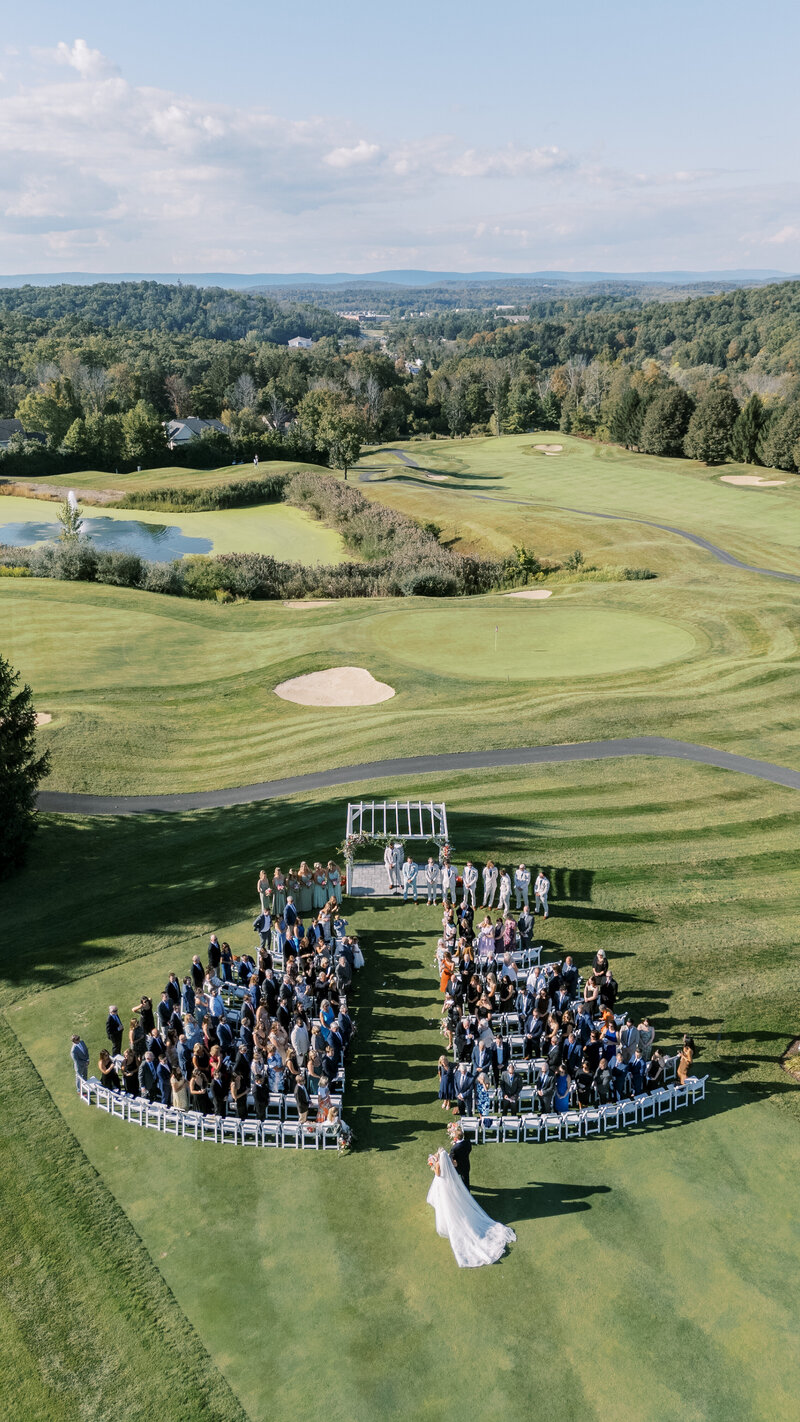 Bride and groom hold hands at wedding altar outside of the Anthony Wayne House in Pennsylvania