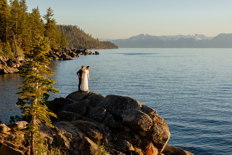 A couple looks out at Lake Tahoe during their lakeside elopement in Nevada.