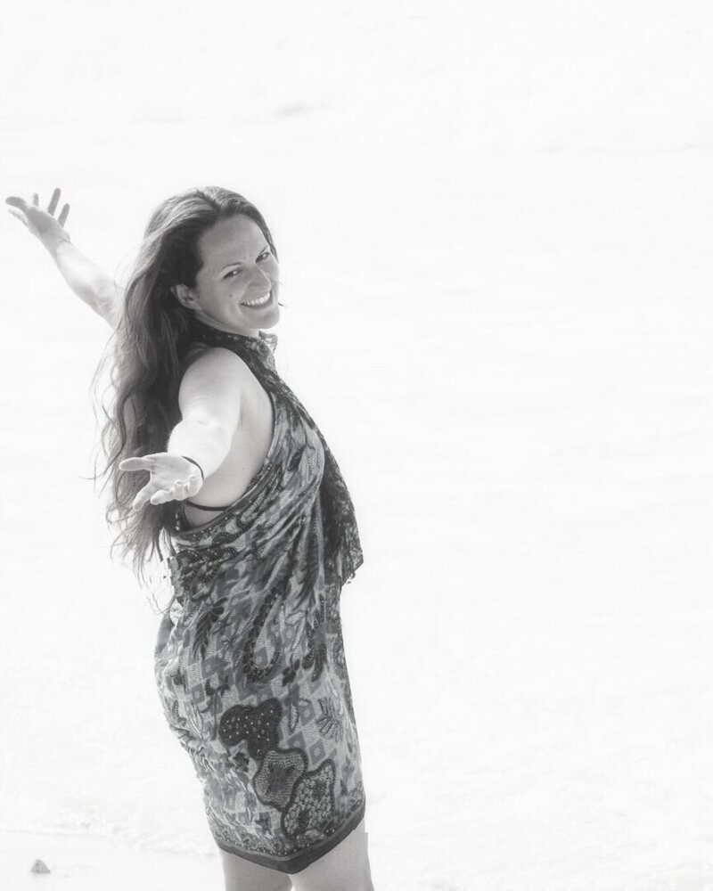 julie rousseau on the beach in Bimini Bahamas with arms wide open