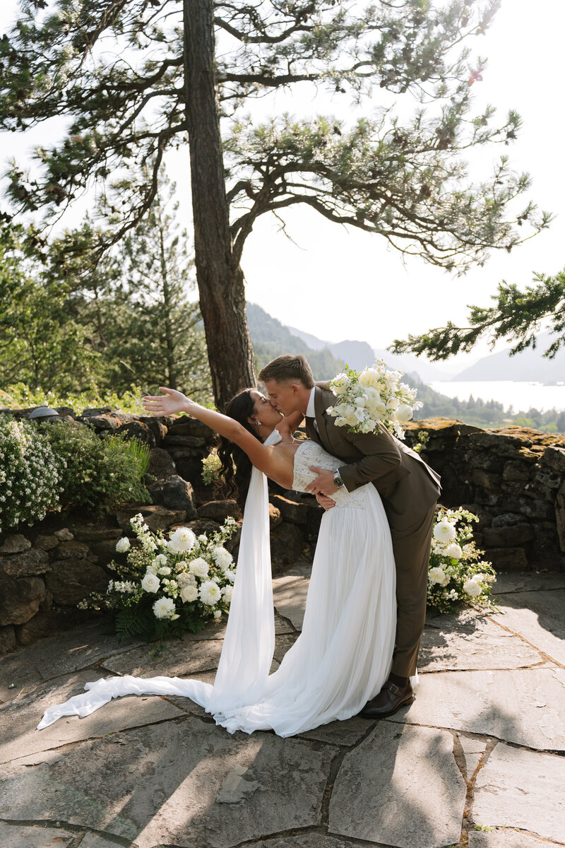 Tana & Eliot give a smooch after cutting the cake on their wedding day
