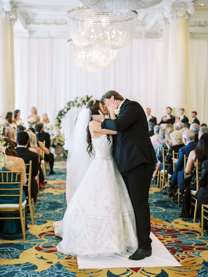 A fine art wedding ceremony moment under a chandelier, photographed by a Seattle and Washington DC destination wedding photographer.