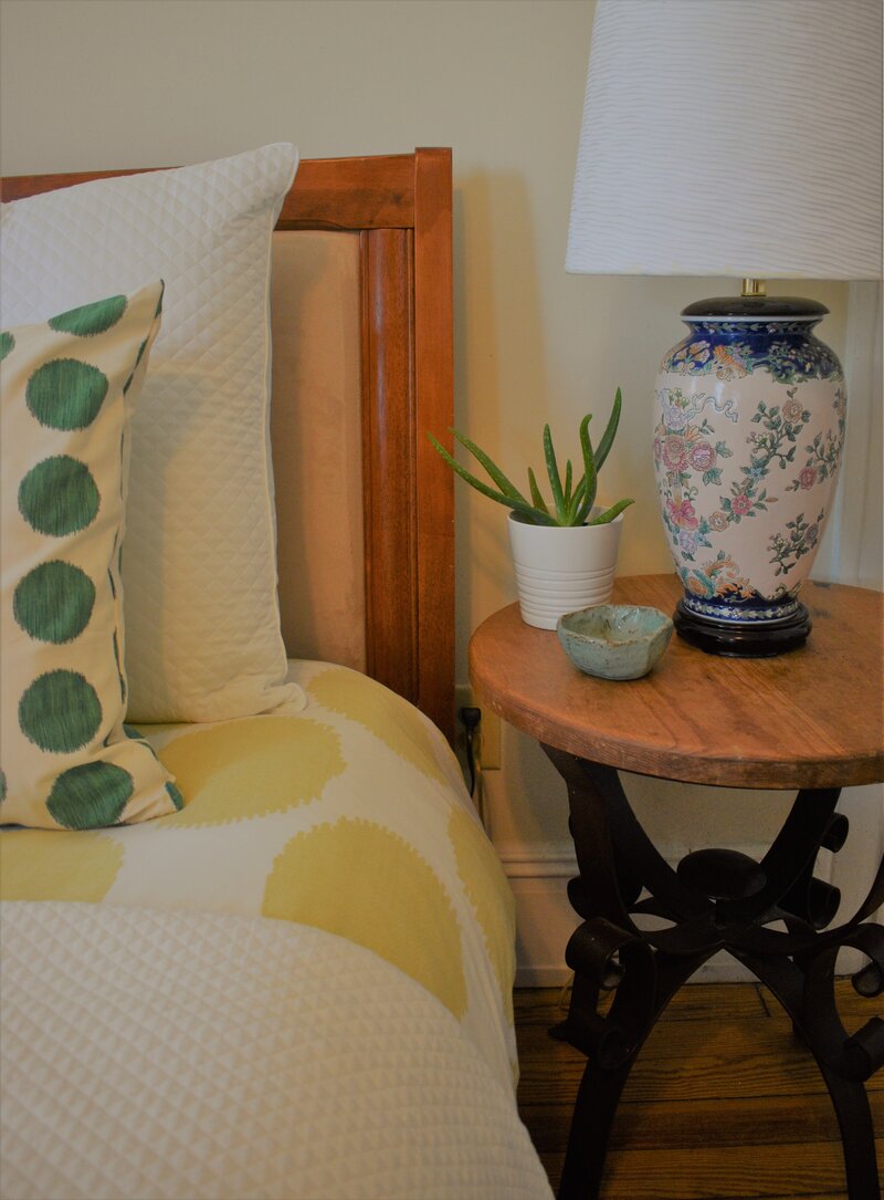 Bedside table with plant and lamp