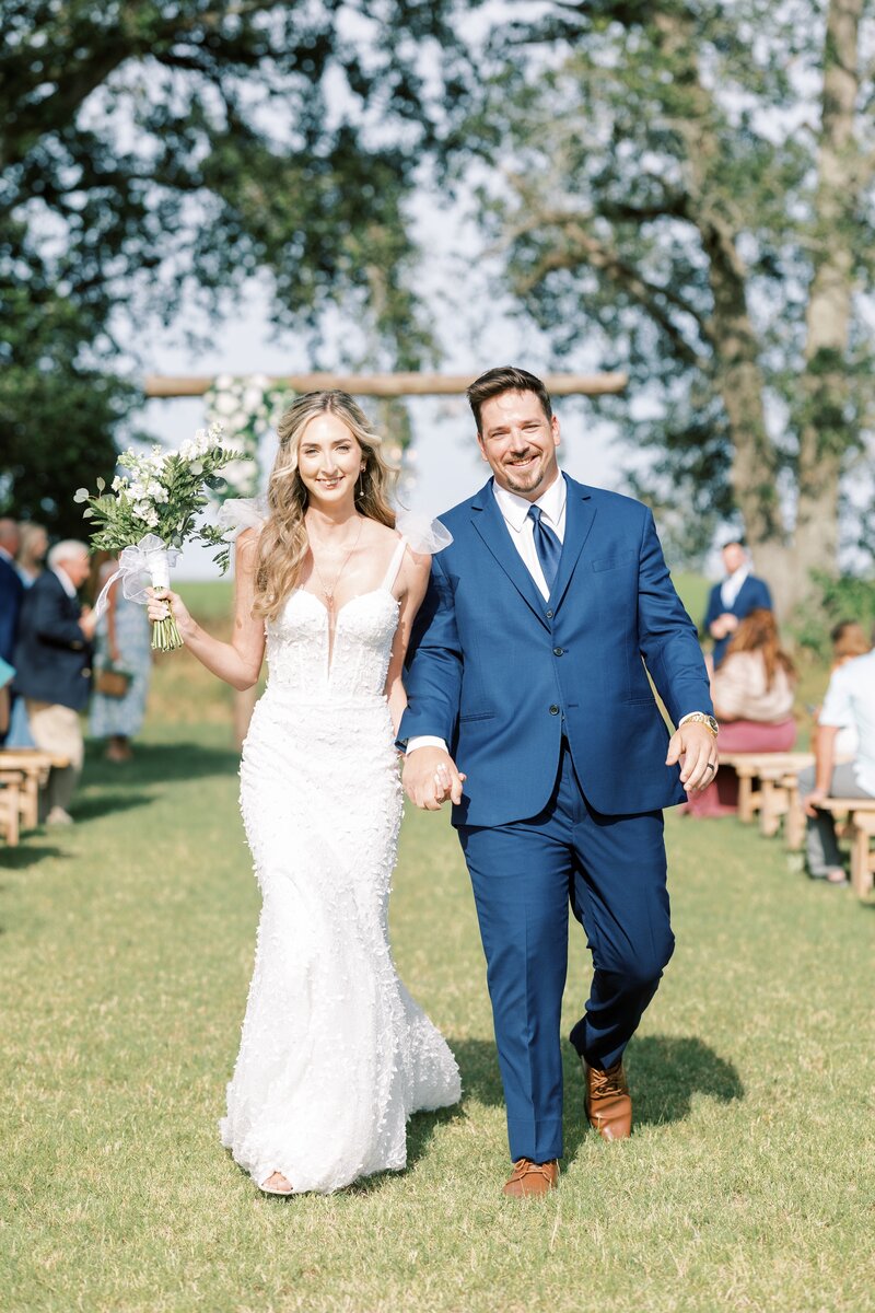 bride and groom joyfully exiting wedding ceremony together