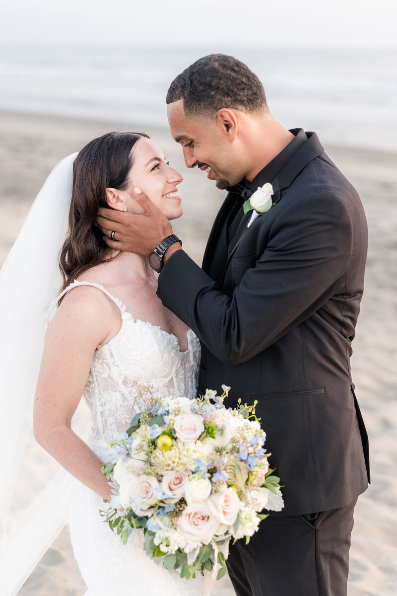 bride and groom walking on the beach at their Catamaran Resort San Diego wedding