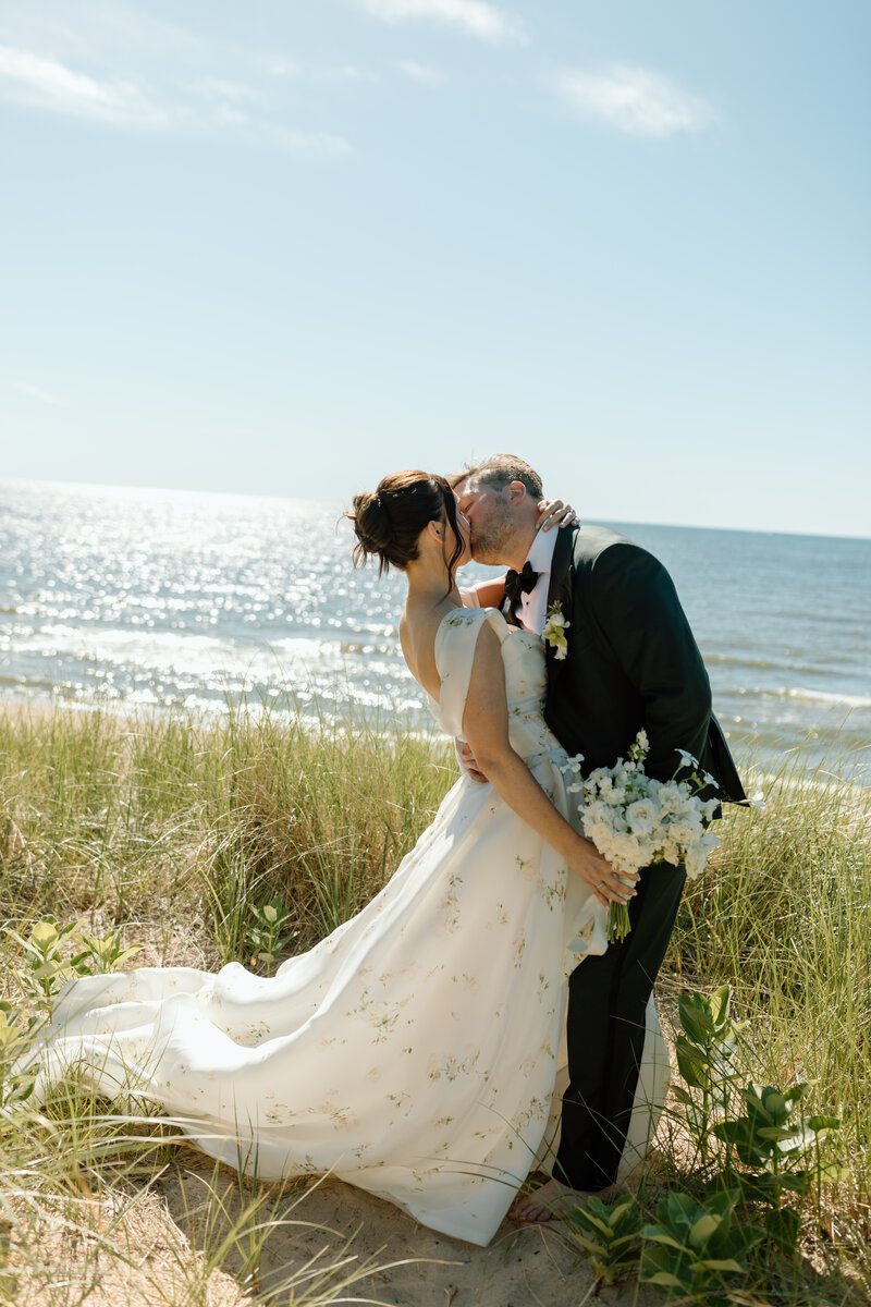 bride and groom hugging on beach