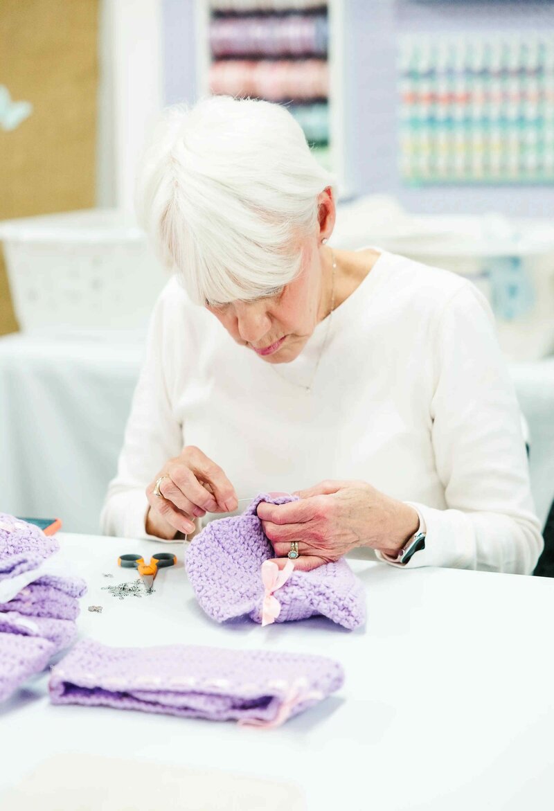 woman sews cradle for baby in Heaven