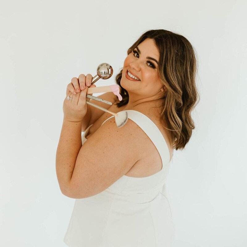 Macayla Hopper holding professional skincare tools used for facials and waxing services in Hartselle AL