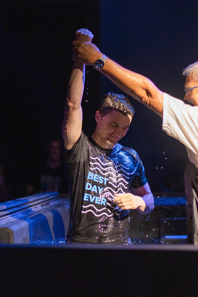 Young man being water baptized at a non-denominational church in Fayetteville, NC. 