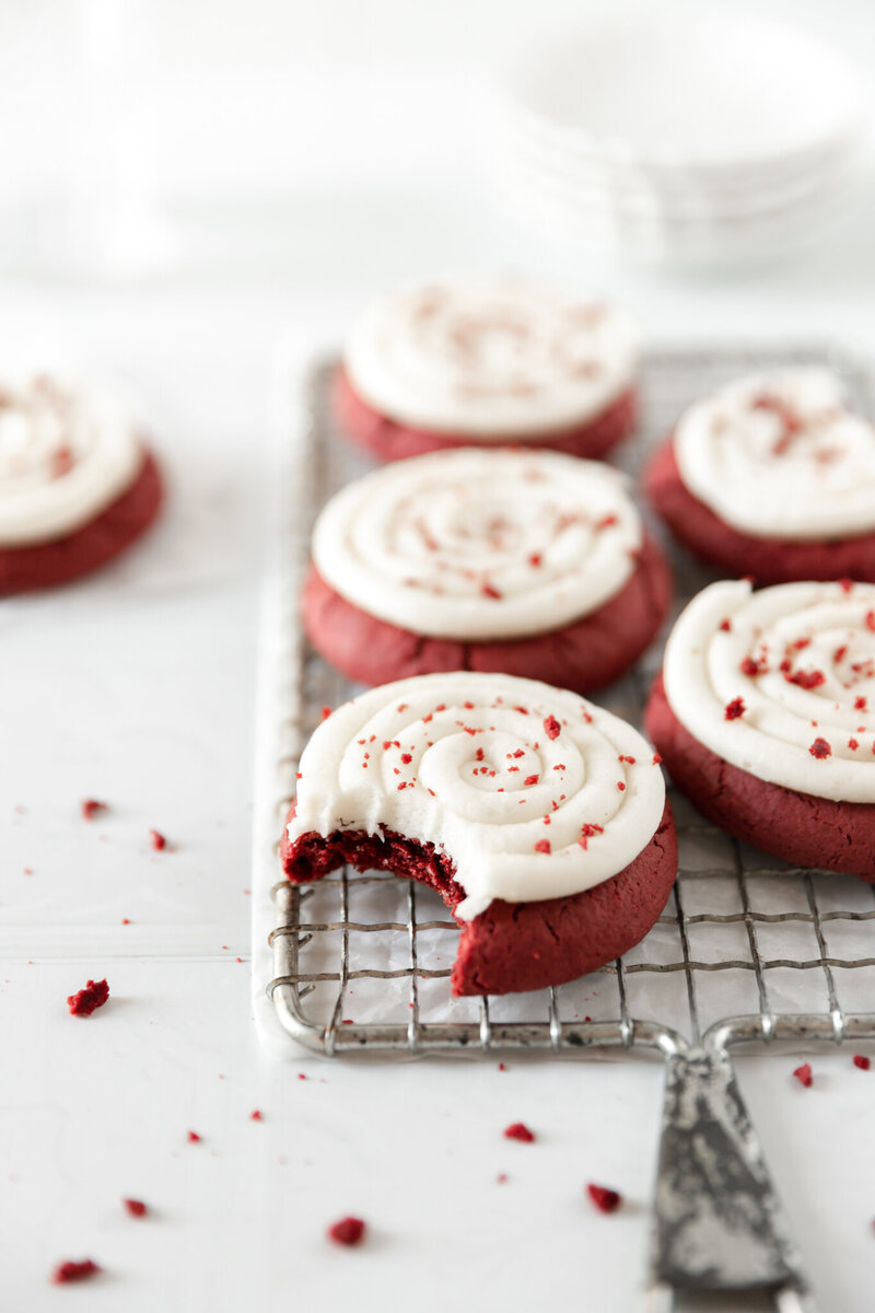 red velvet cookies topped with cream cheese frosting