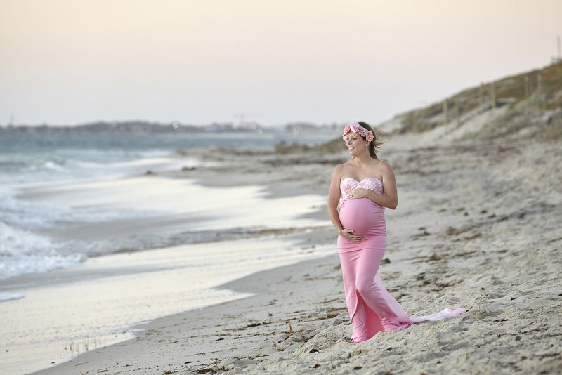 Pregnant women on beach at sunset