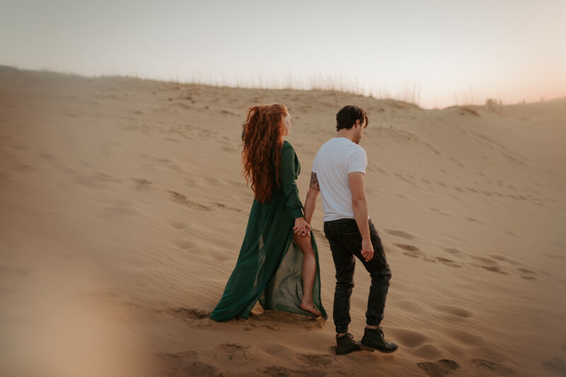 couple holding hands in desert