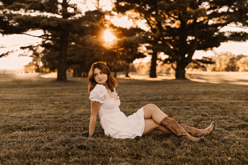 senior photos in a white dress and cowboy boots