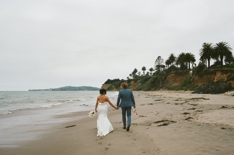 newlyweds walking on beach