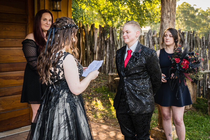 An LGBTQ+ couple reads their vows during their backyard ceremony with their two close friends in Roanoke, Virginia.