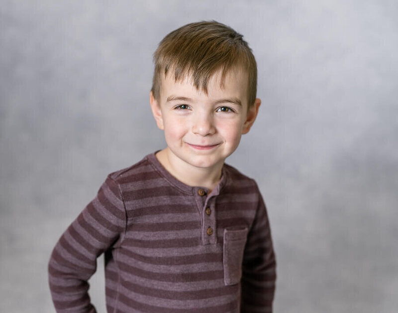A kid poses with their hands on their hips.