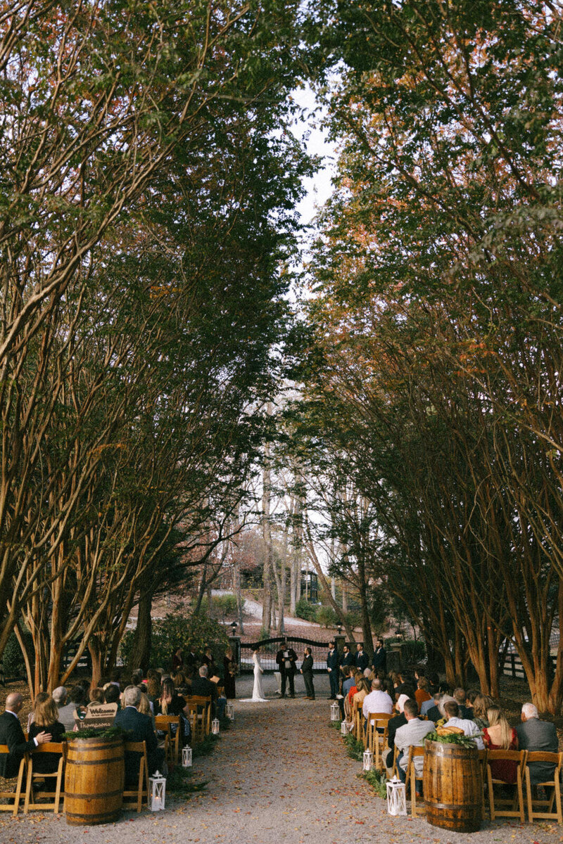 Fall wedding ceremony with a beautiful golden glow as the Bride and Groom exchange their vows in front of their family and friends in North Carolina, by Andrea-Marie Photography
