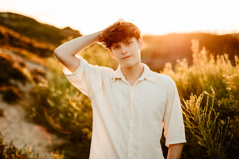 Senior boy backlit at the beach