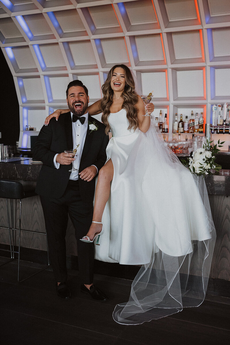 Bride and Groom pose at bar in Hotel Washington