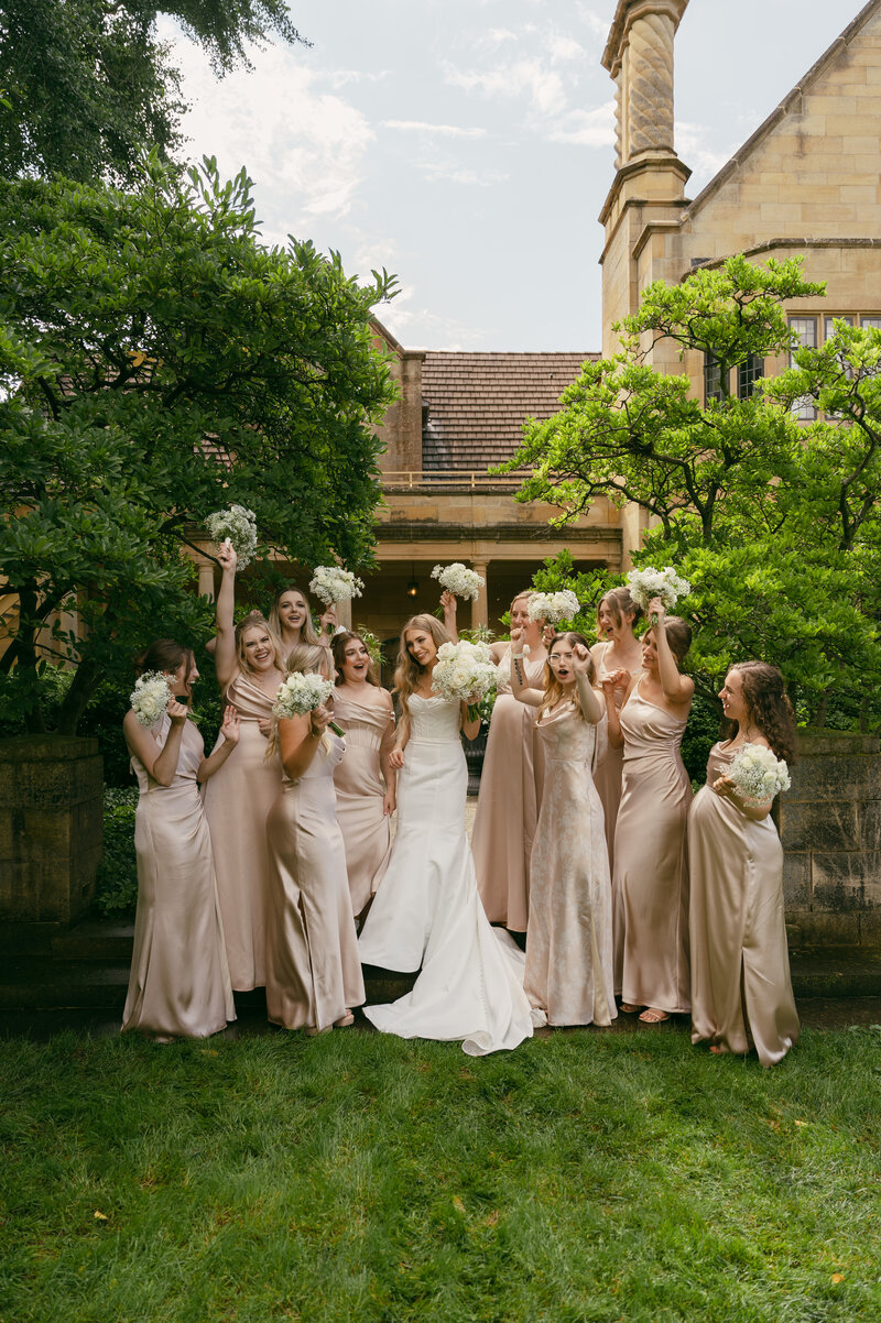 Bride with her bridesmaids summer wedding at the Paine Art Center and Gardens.