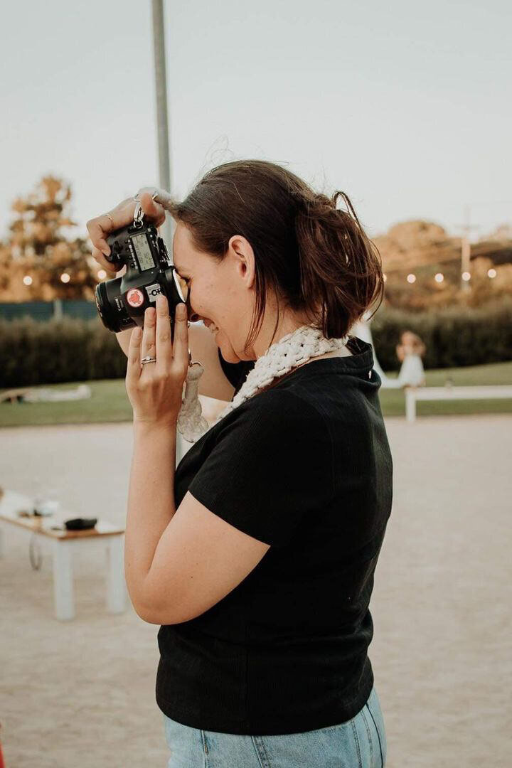 Close up of photographer taking a photo and laughing