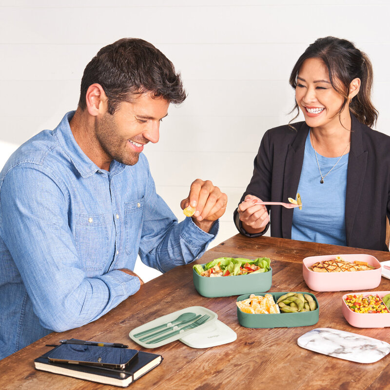 People eating an assortment of food from a Bentgo lunch container