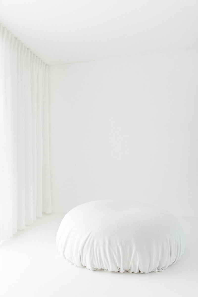 Beanbag covered in white fabric in white studio