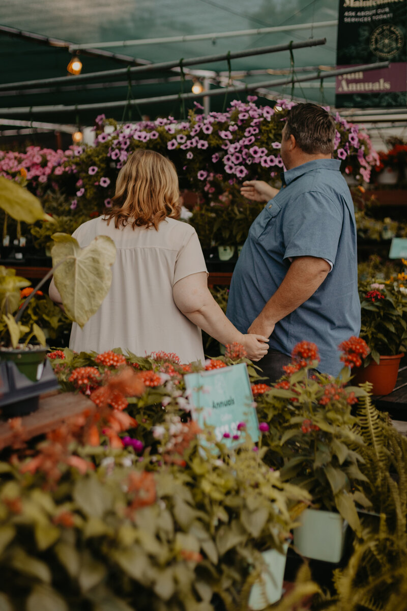 couple looking at plants in farmers market