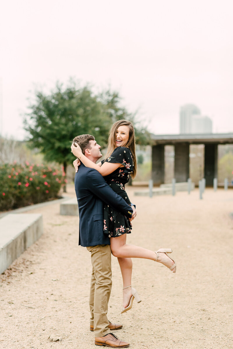fun couple posing for engagement photos in Houston