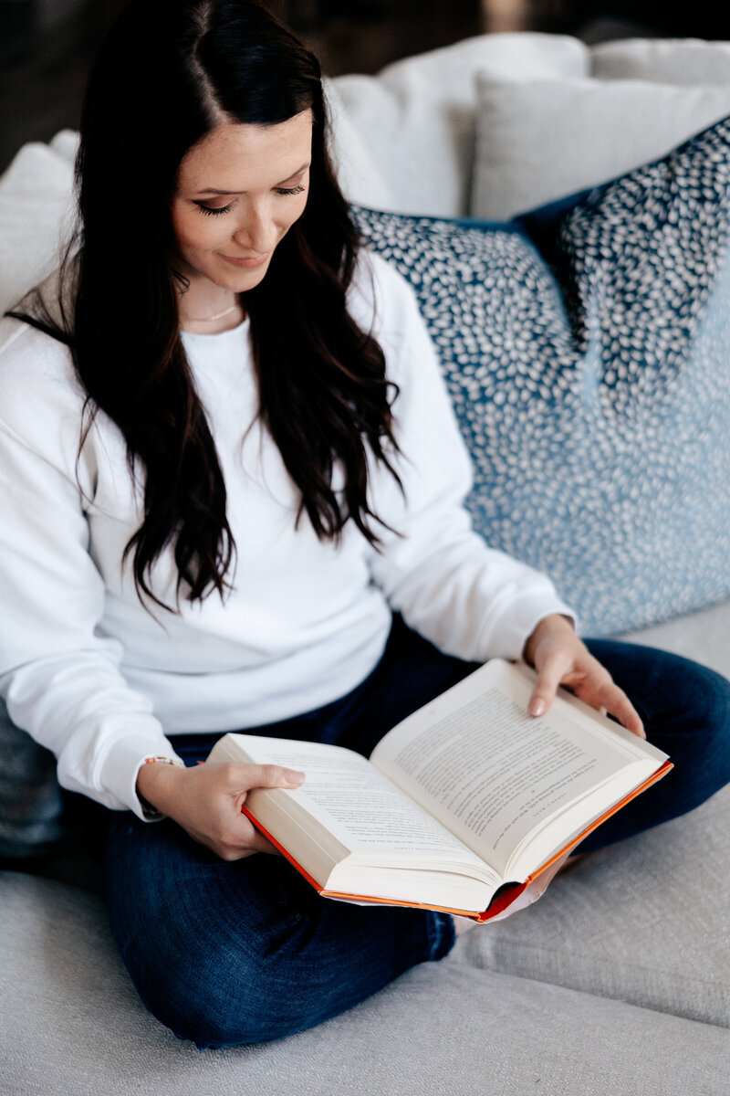 Above view of woman reading on couch