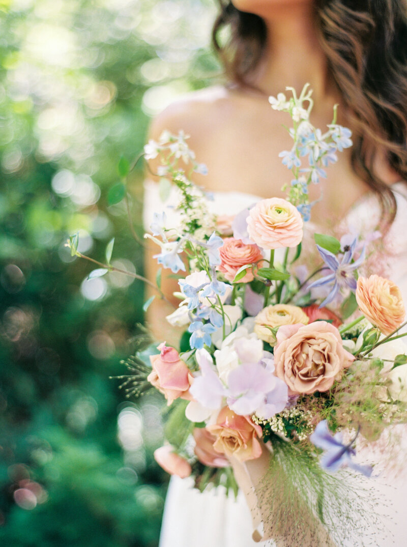 Bride With Long Flowy hair with peach, pink and purple wedding bouquet
