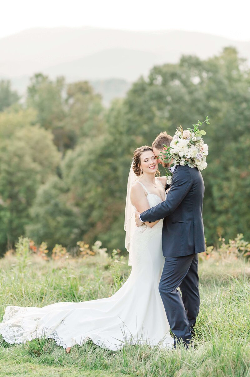 Bride and groom in a field in asheville during their nc elopement